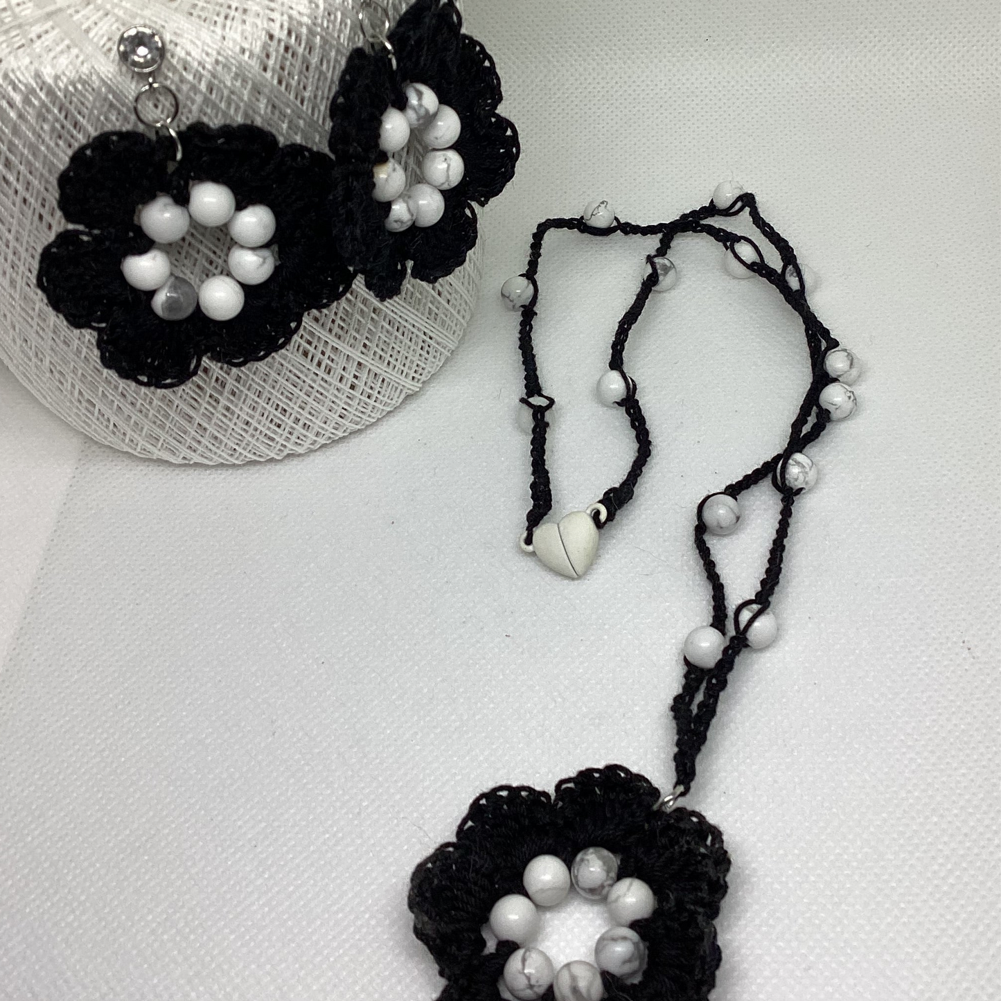 black flower necklace and earring set, made with white howlite beads, flower necklace has a magnetic heart clasp, earring have a rhinestone stud