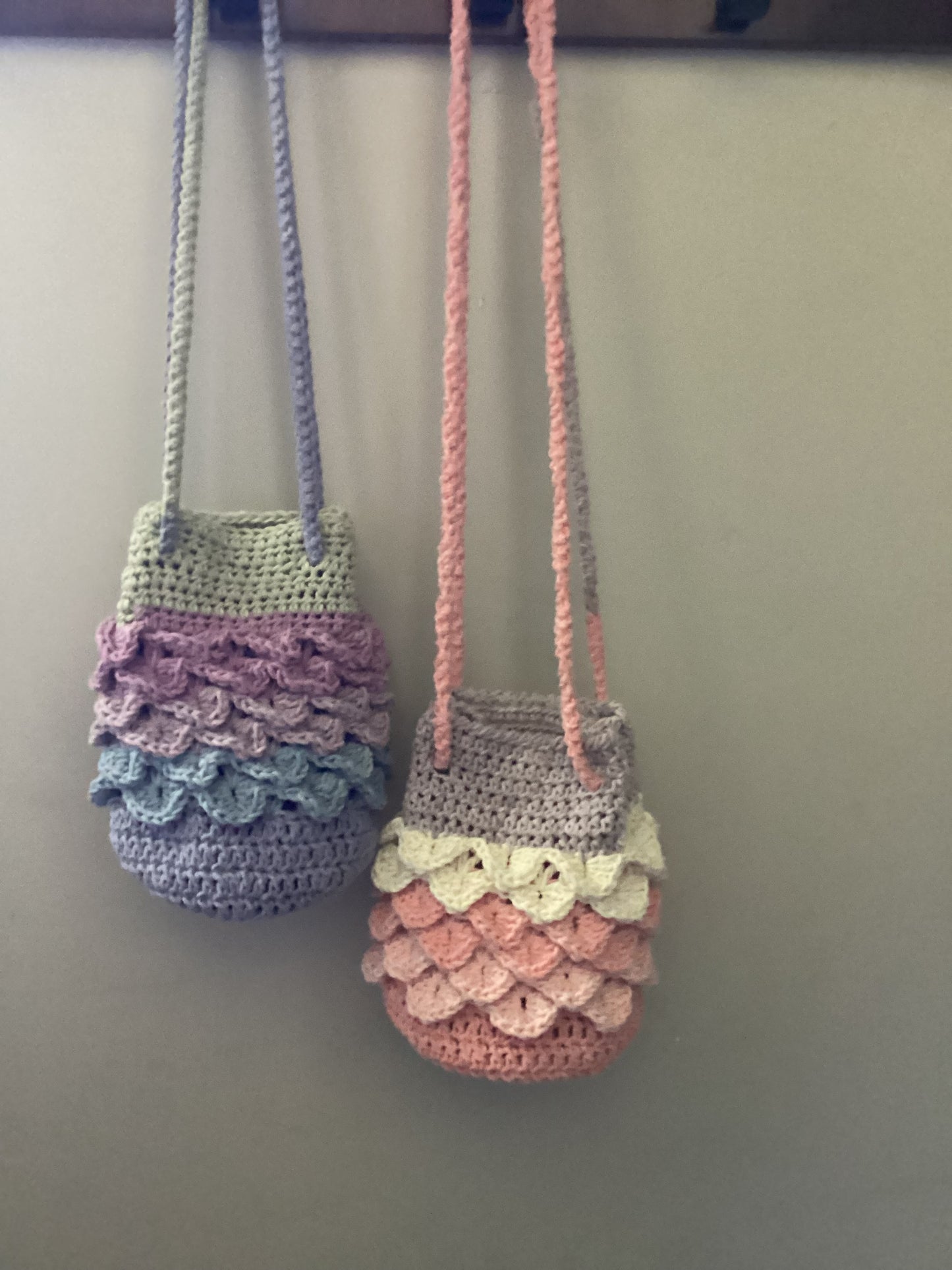 mermaid purses hanging on hooks vibrant colors