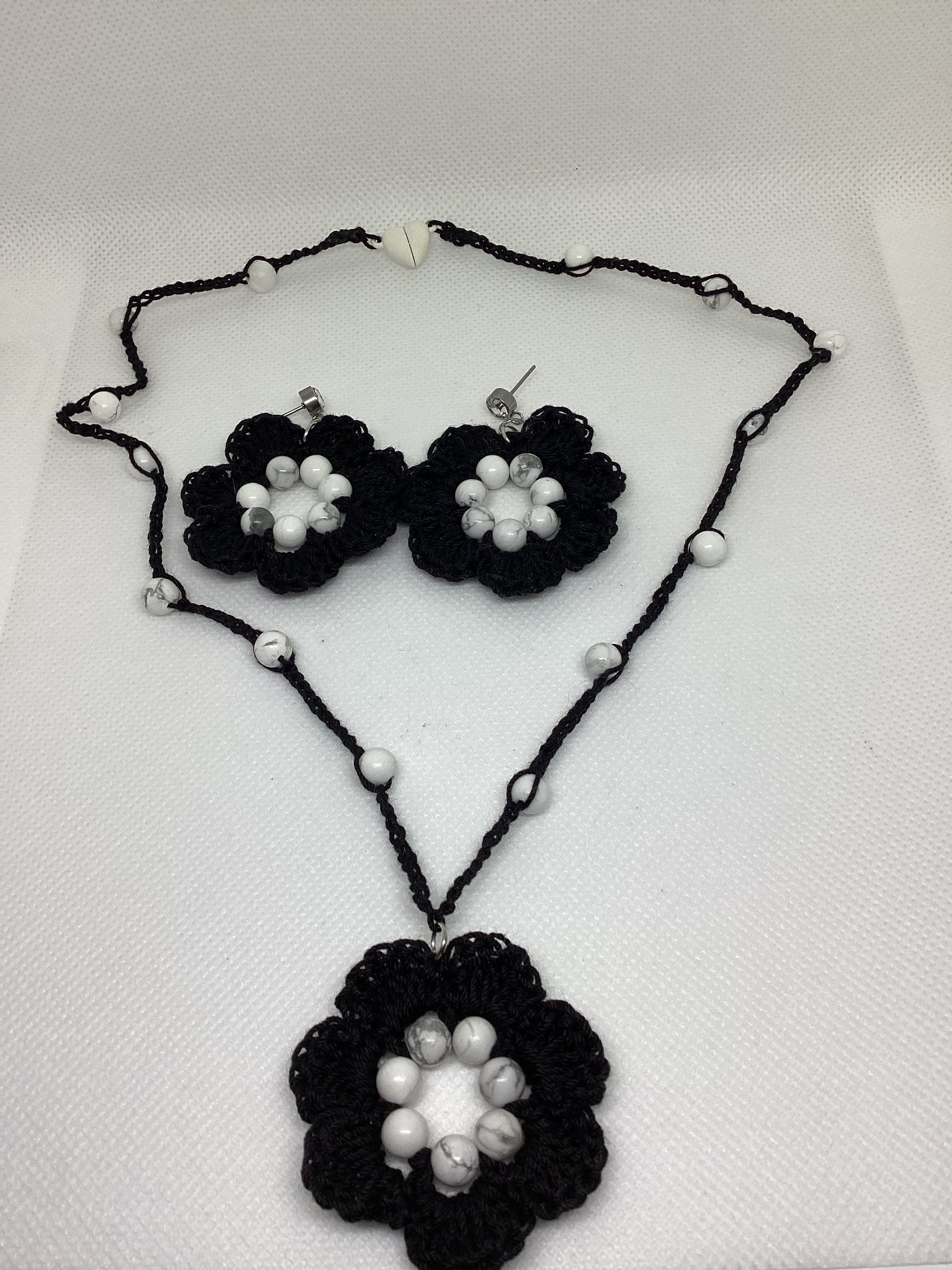 Black cotton floral necklace with white beads and earrings with studs