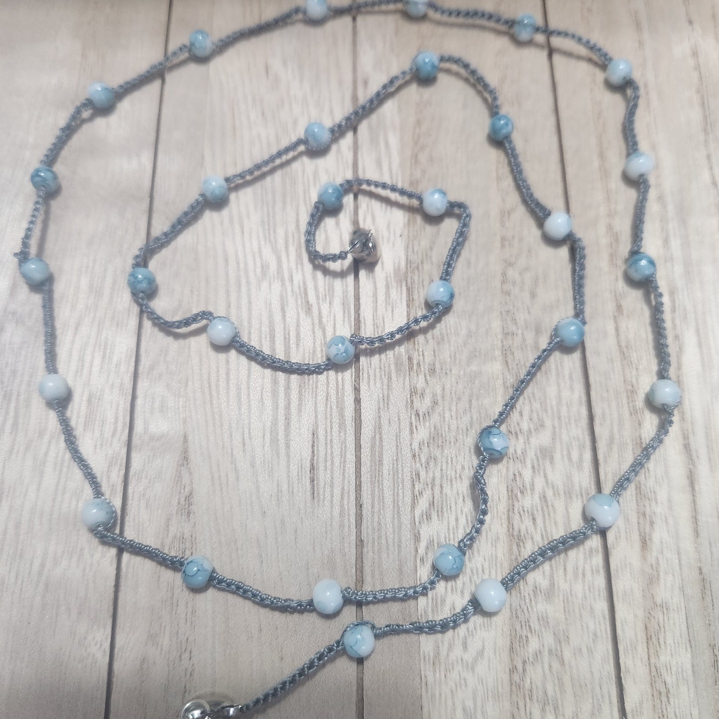 The versatile bracelet!  blue beads with silver s-lon cord