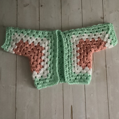 Crocheted heart-patterned item on a wooden surface