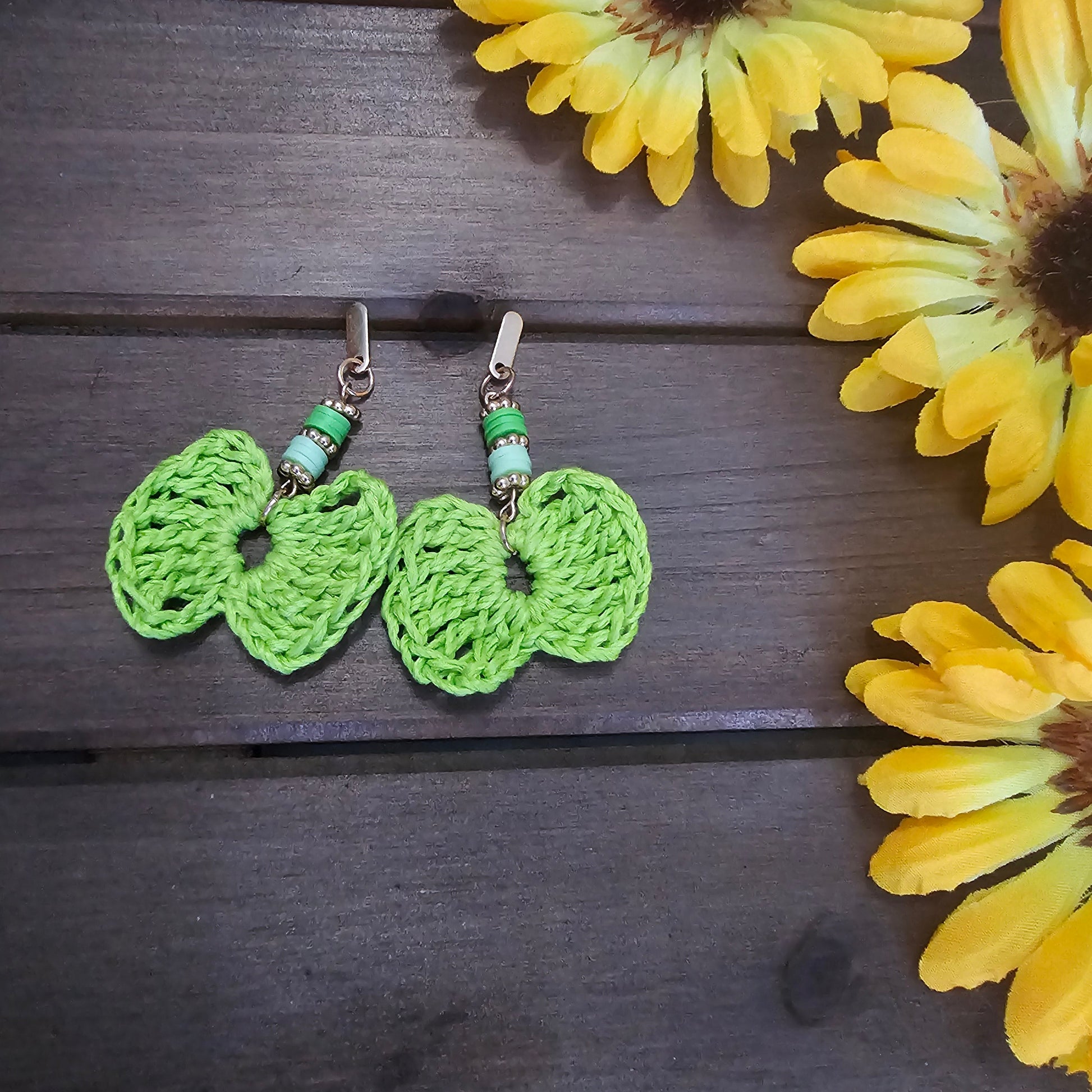 beaded bow earrings green made with green clay beads and gold earring findings  and a bamboo crocheted bow 