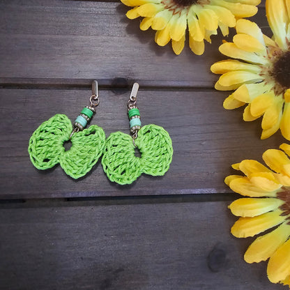 beaded bow earrings green made with green clay beads and gold earring findings  and a bamboo crocheted bow 