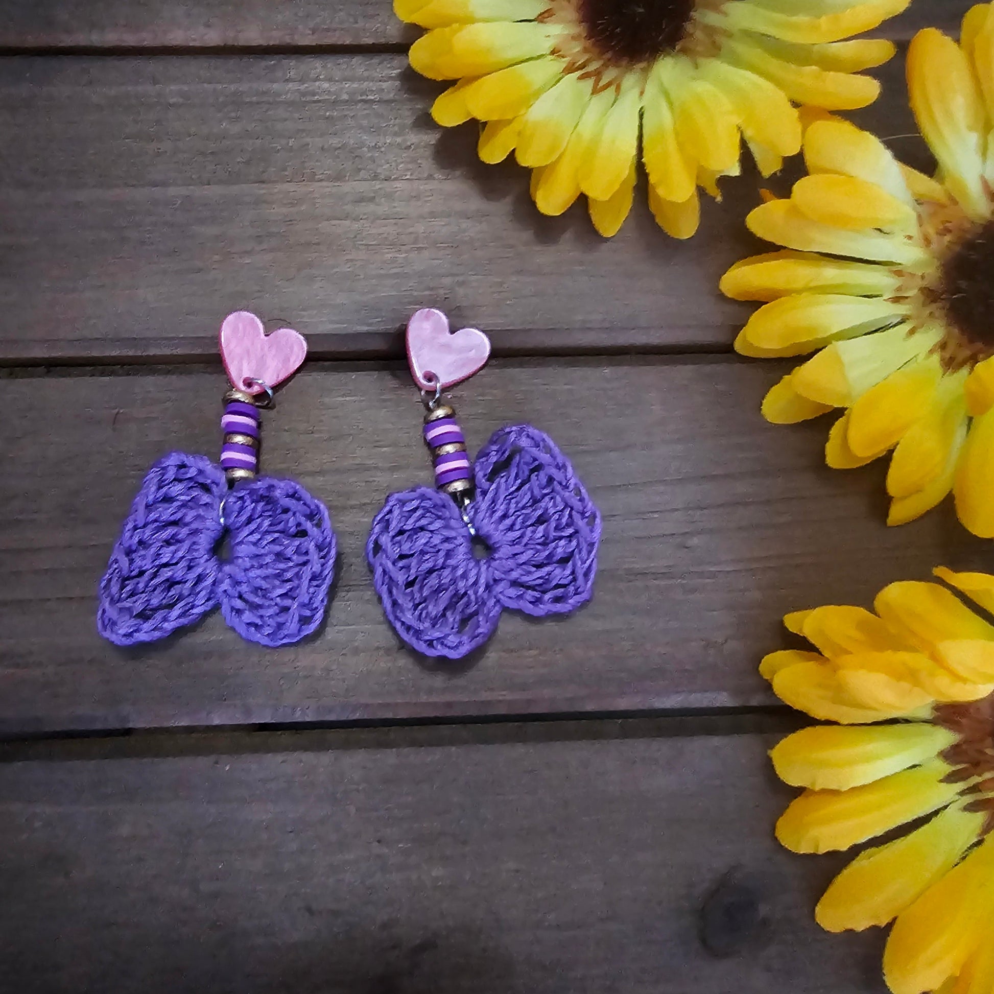 beaded bow earrings purple made with green clay beads and heart earring findings  and a bamboo crocheted bow 
