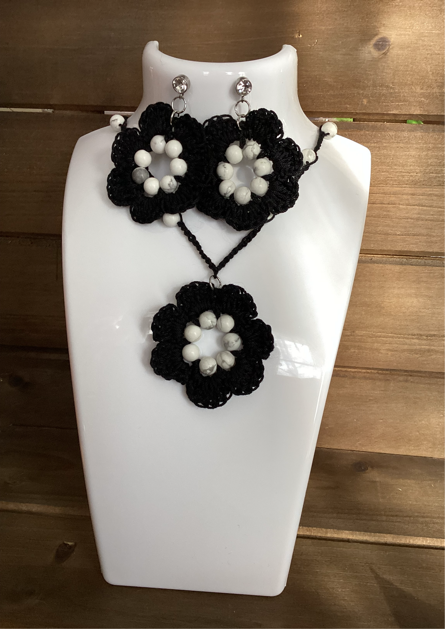 black flower necklace and earring set, made with white howlite beads, flower necklace has a magnetic heart clasp, earring have a rhinestone stud