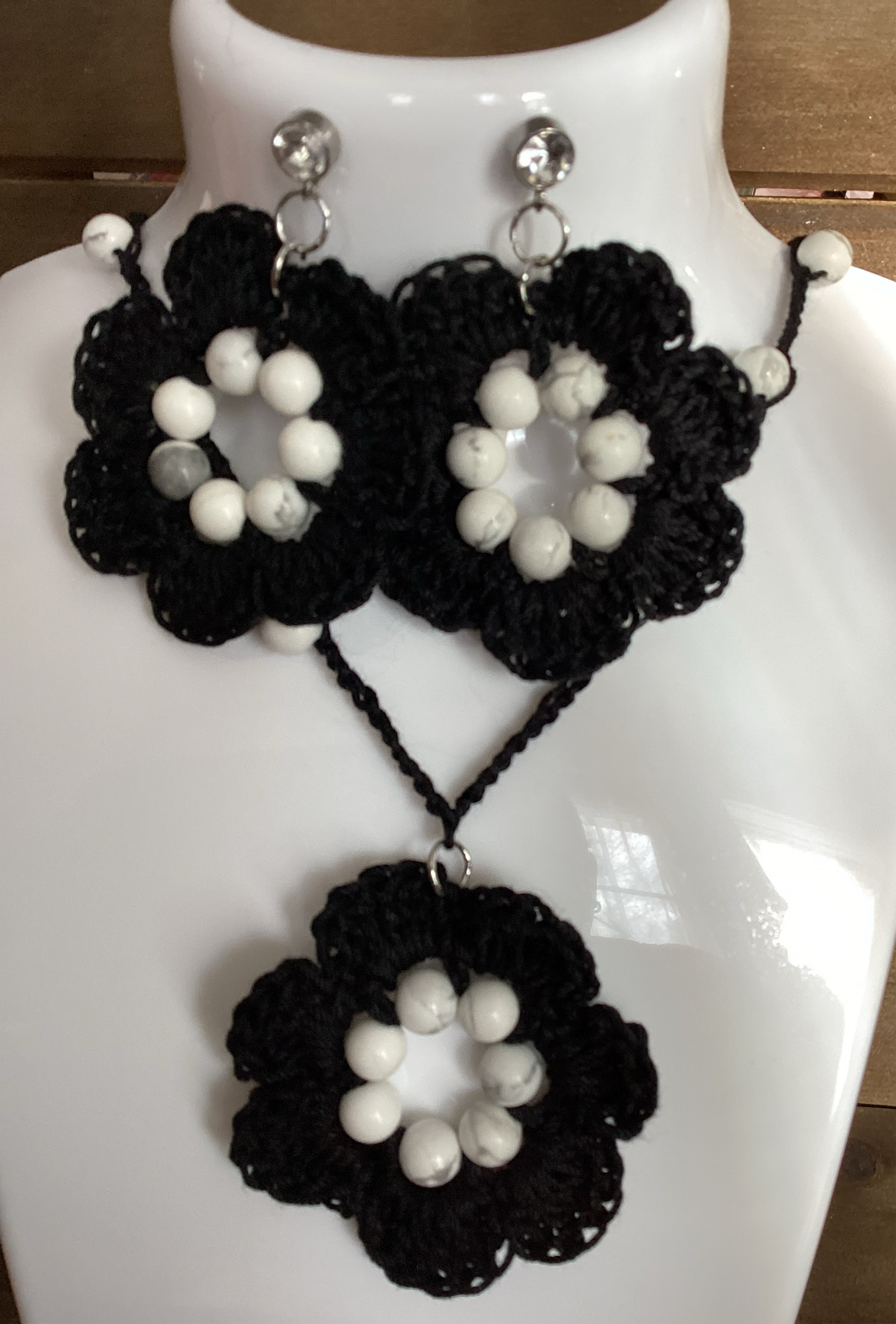 black flower necklace and earring set, made with white howlite beads, flower necklace has a magnetic heart clasp, earring have a rhinestone stud