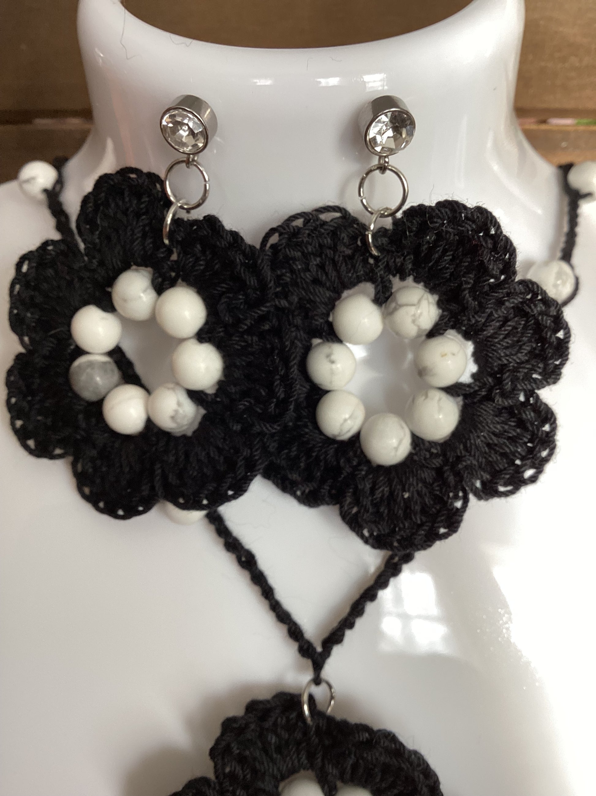 black flower necklace and earring set, made with white howlite beads, flower necklace has a magnetic heart clasp, earring have a rhinestone stud