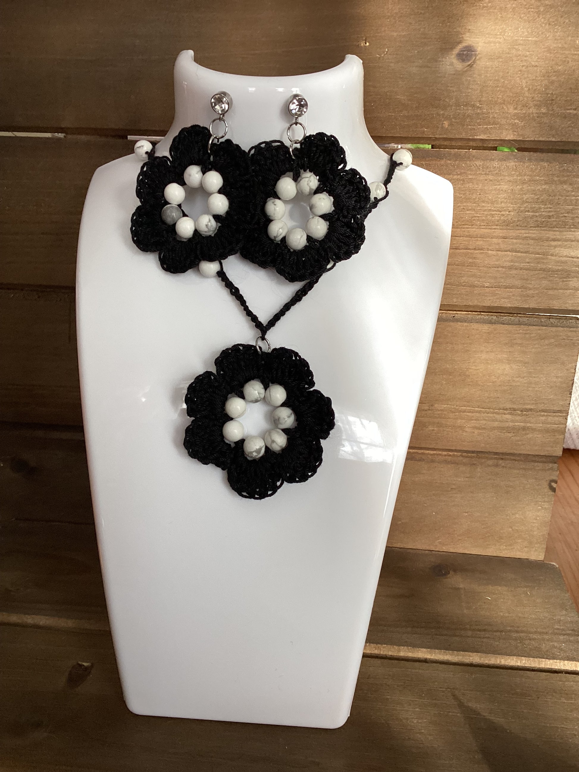 black flower necklace and earring set, made with white howlite beads, flower necklace has a magnetic heart clasp, earring have a rhinestone stud