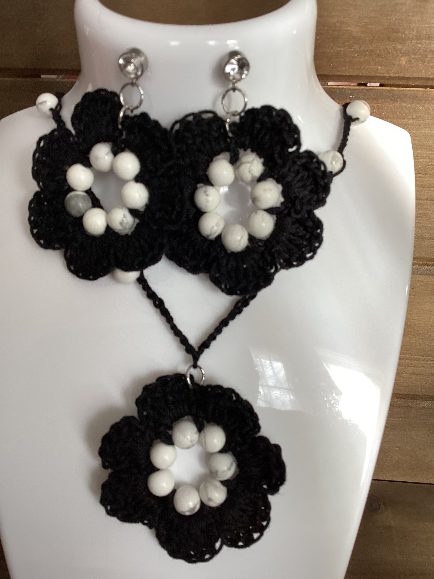 black flower necklace and earring set, made with white howlite beads, flower necklace has a magnetic heart clasp, earring have a rhinestone stud