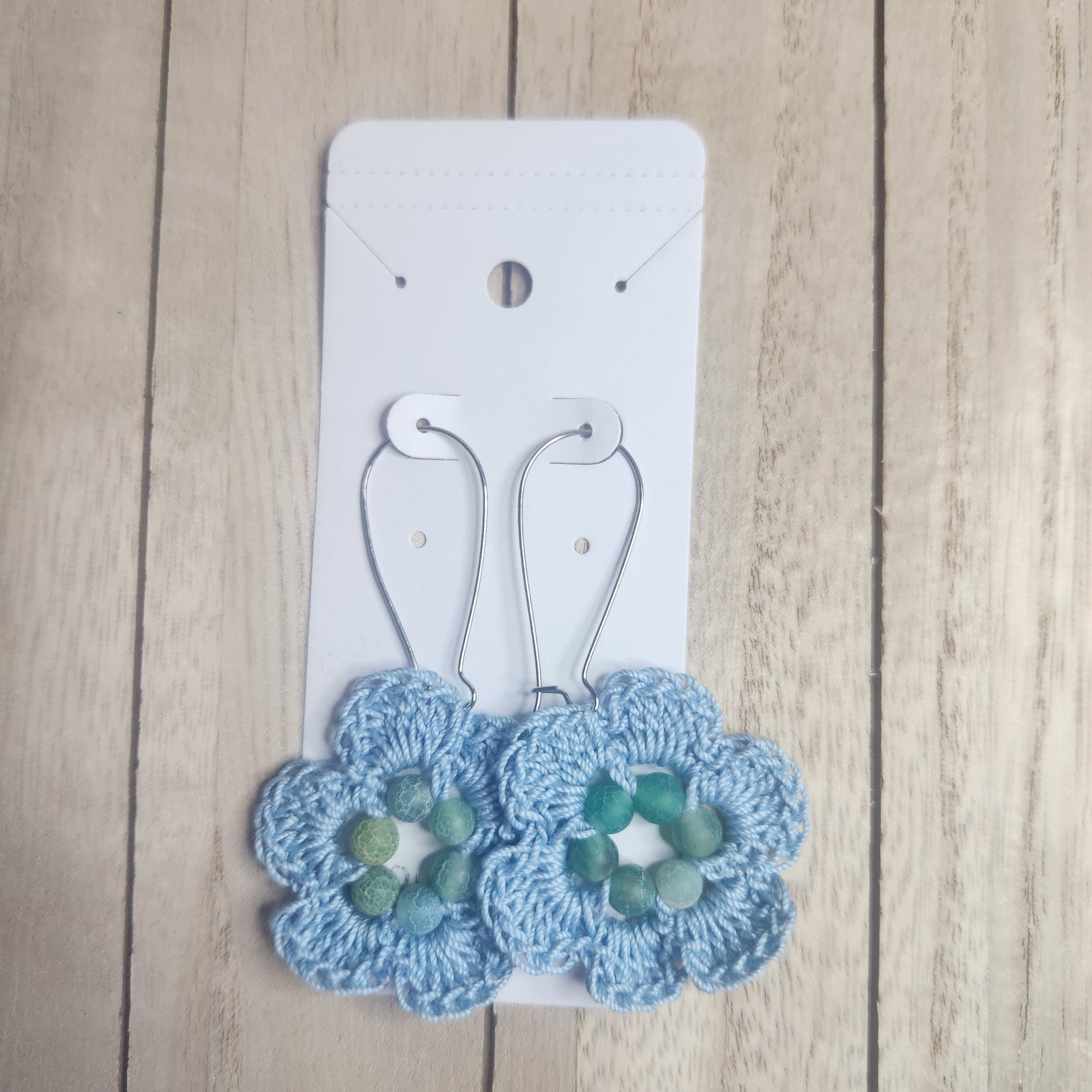 floral earrings  blue on and earring card 